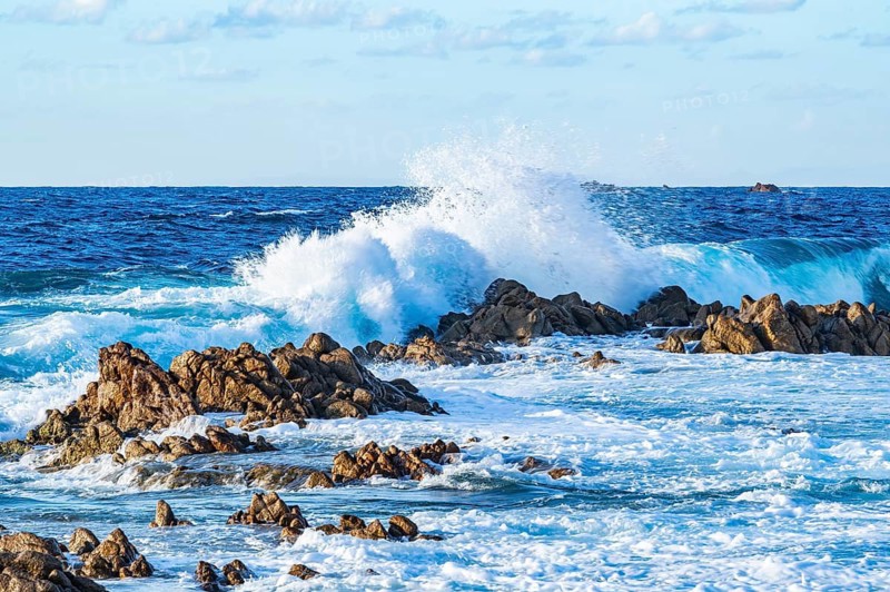 Braking waves at the coastline of Marinedda Coast at sunset, Sardinia, Italy