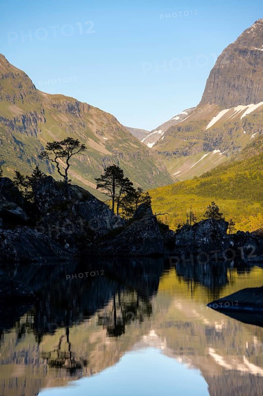 Picturesque mountain landscape in the Innerdalen high valley, silhouettes in front of mountain peaks, reflection in Lake Innerdalsvatna, Trollheimen Mountain Area, Sunndal, Møre og Romsdal, Norway