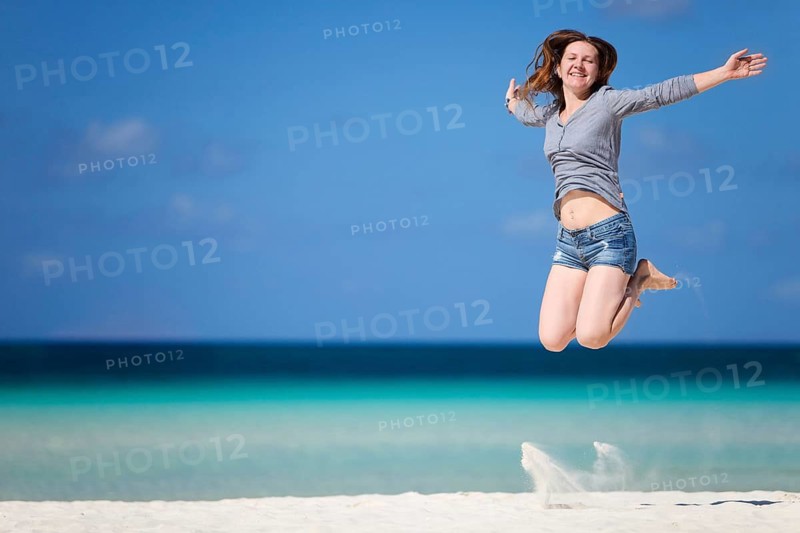Vacation delights, a young woman jumping in the air for joy, beach, Boracay, Philippines, Boracay, Philippines
