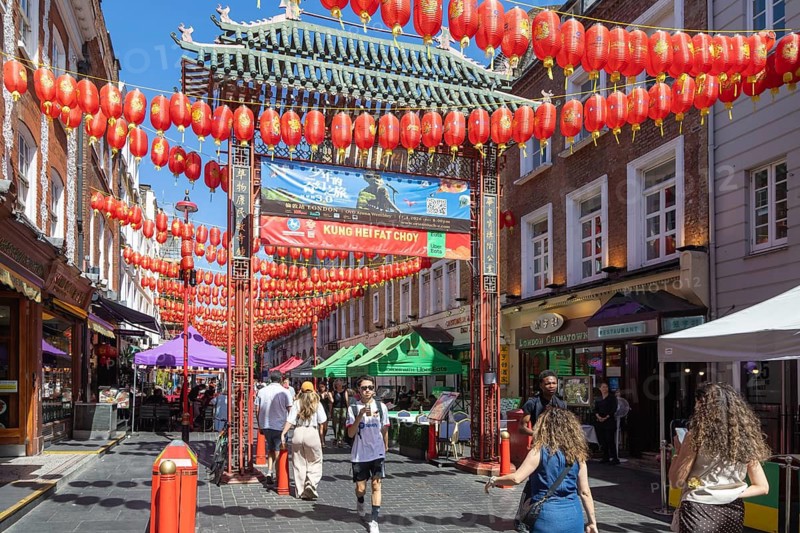 Red Chinese lanterns suspended over street in Chinatown, Gerard Street, Soho, London, England, UK