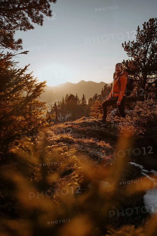 Hiker in the Allgäu at sunset in spring on the Zirmgrat near Pronten in the Allgäu