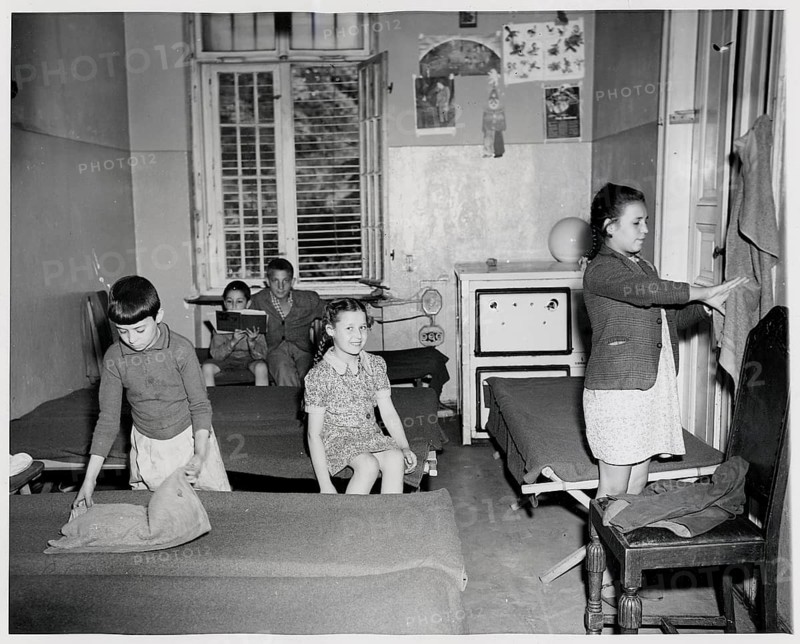 Jews, Displaced Persons, Berlin Düppel, Displaced Camp, Jewish Orphanage, Children playing in a room with simple beds and a window, 19.8.1946