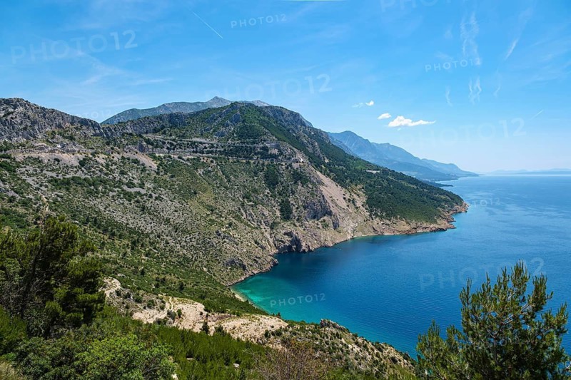 Wide coastal landscape with mountains and blue sea under clear sky, peaceful atmosphere, Pisak, Split-Dalmatia County, Croatia