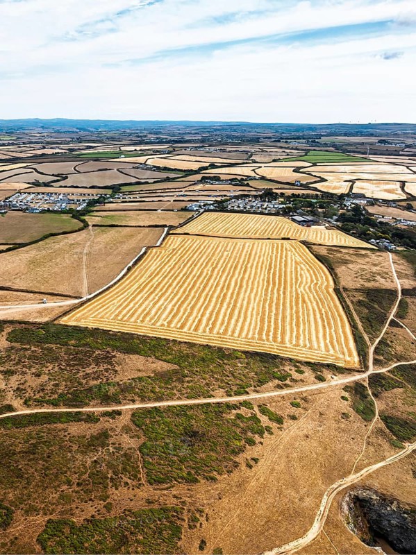 Farms and Fields over Cliffs and Porthcothan Bay from a drone, Porthcothan, Padstow, Cornwall, England, United Kingdom, Summer 2026