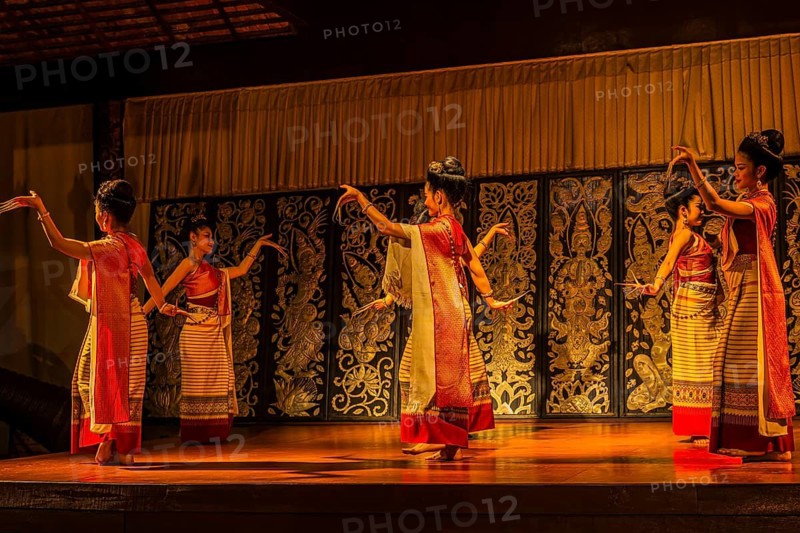 Young Thai women in traditional dress showing a traditional dance, Old Chiang Mai Cultural Center, Chiang Mai, Thailand