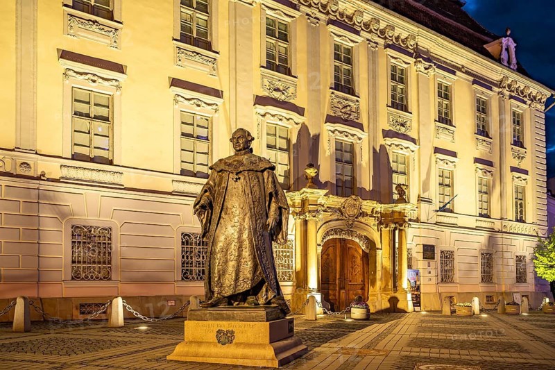 Statue of Samuel of Brukenthal in front of the Brukenthal Museum on the Pia?a Mare Grand Ring at dusk, Sibiu or Sibiu, Transylvania, Romania