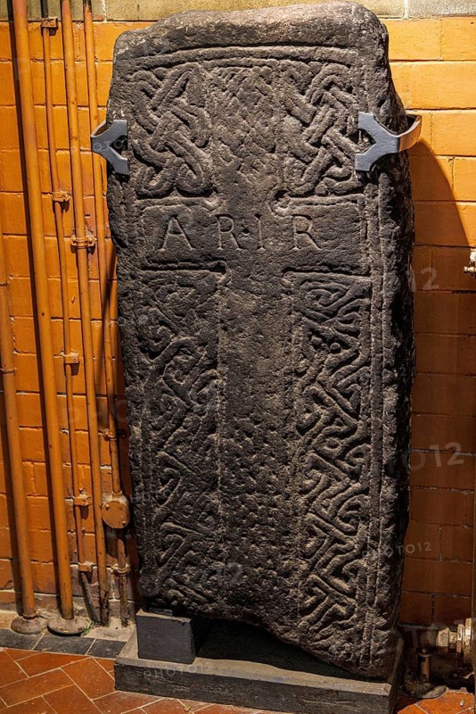 Early medieval carved cross slab decorated with Celtic interlace, part of the early medieval Govan Stones collection at Govan Old Parish Church, Glasgow, Scotland, United Kingdom