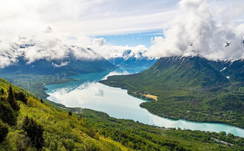View of snowy mountains in spring and turquoise blue Kenai Lake, Slaughter Ridge Trail, Cooper Landing, Kenai Peninsula, Alaska, USA