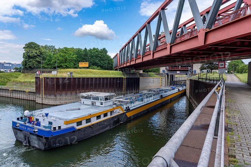 Cargo ship, tanker, leaves the port canal in the port of Duisburg-Ruhrort, enters the Duisburg-Meidrich canal lock, to continue on the Rhine-Herne Canal eastwards, North Rhine-Westphalia, Germany