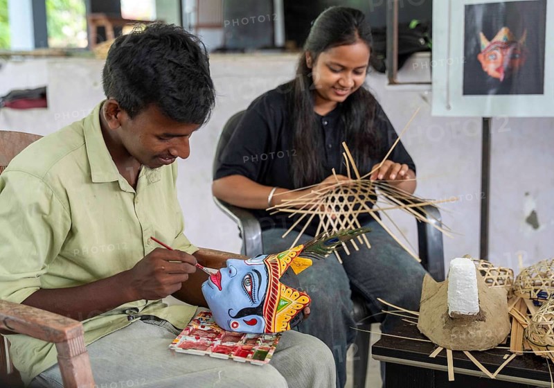 A student paints the facial details of a traditional mask at a mask-making workshop during an internship programme at J.D.S.G. College on Wednesday 8 July 2026 at Bokakhat, in Golaghat district of Assam. Under the guidance of artisan Khagen Goswami from Sukumar Kala Peeth, Majuli, participants are trained in the traditional mask-making techniques of Majuli's centuries-old Sattriya cultural heritage