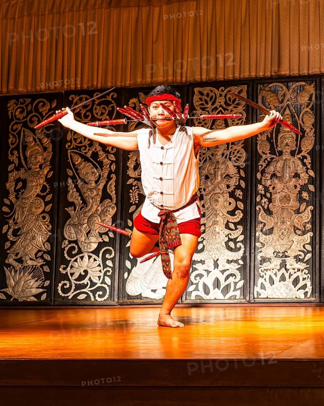 Young Thai man in traditional clothing in a historic show with knives and swords, Old Chiang Mai Cultural Center, Chiang Mai, Thailand