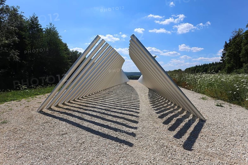 Art in public space, sculpture made of aluminum profile pipes by artist Martin Burchard, life's horizon path near Mundingen, light and shadow, gravel, clouds, blue sky, walk-in art, paths of reflection and refreshment on the Ehinger Alb, Baden-Württemberg, Germany