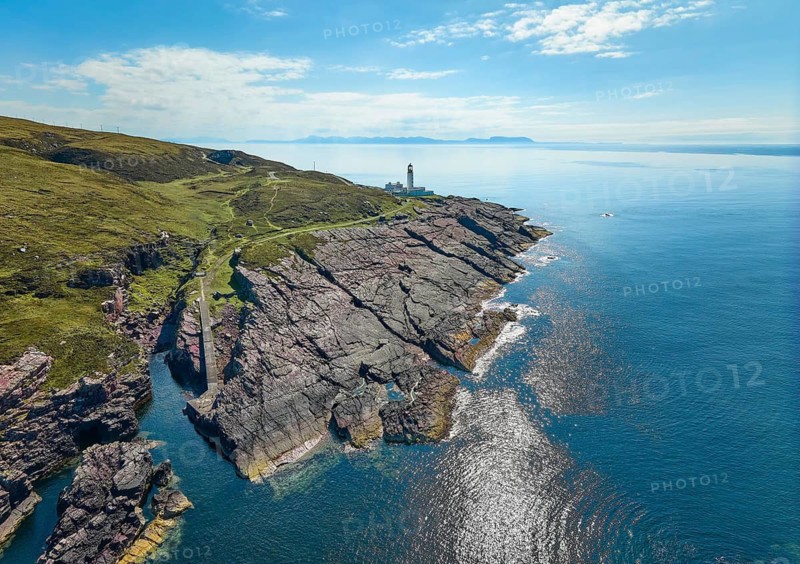 Aerial photo of the lighthouse on the rocky red cliffs of Rua Reidh point, Gairloch, Scotland, UK