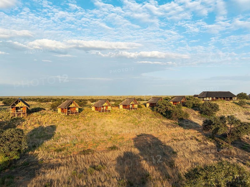 The Ta Shebube Rooiputs Lodge in the Kalahari Desert during the rainy season with green vegetation. Aerial view. Drone shot. Kgalagadi Transfrontier Park, Botswana