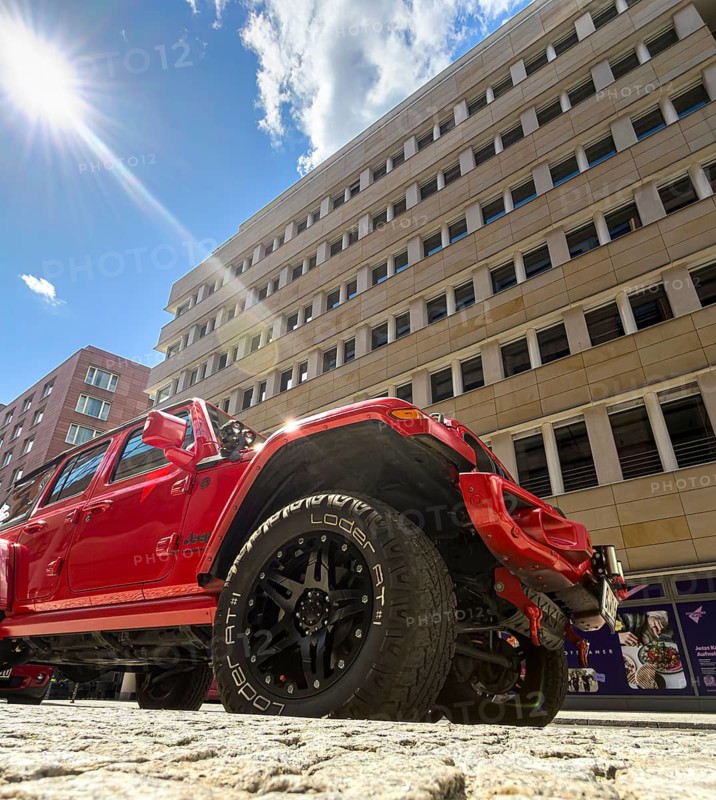 Frog-eye view, red jeep parked against the backdrop of an office complex on Potsdamer Platz, Berlin, Germany