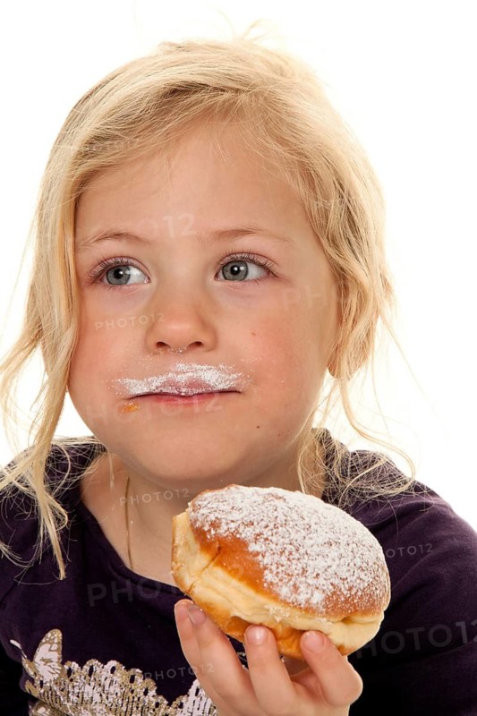 Child in carnival with donuts. Donuts at Mardi Gras. Mardi Gras, Berliner, cake