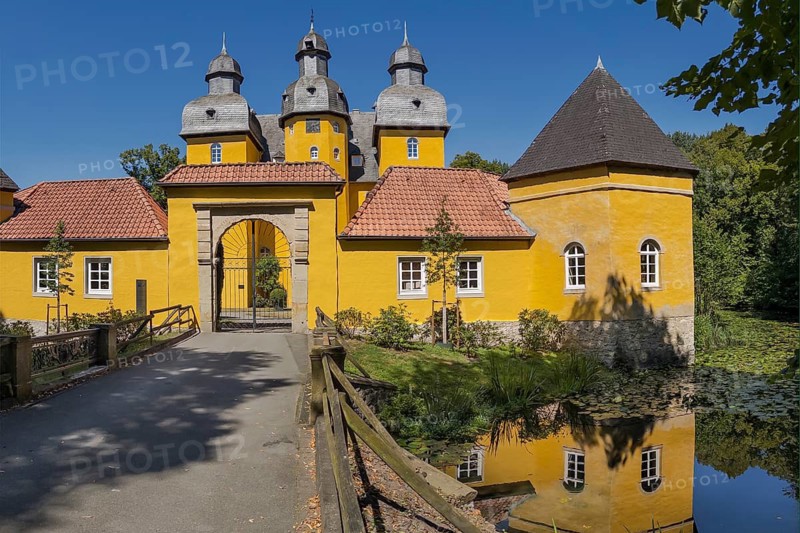 Holter Castle with moat in summer in Holte-Stukenbrock Castle, North Rhine-Westphalia, Germany
