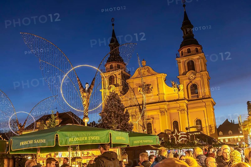 Baroque Christmas market with illuminated angels between the Protestant City Church and the Catholic Church of the Most Holy Trinity. Sights on the market square in the evening. Ludwigsburg, Baden-Württemberg, Germany