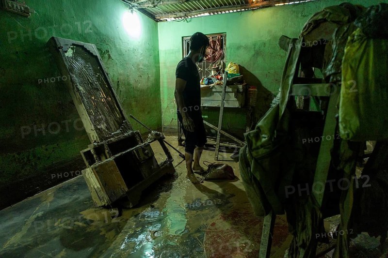Resident walks around inside his mud-filled and flood-damaged home after floodwaters receded on July 26, 2026 in Sivasagar, India. The flood situation in Assam has improved following the recession of floodwaters. However, more than 700, 000 people across 21 districts have been affected by the floods, while the state's death toll has risen to 60