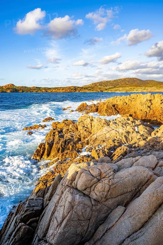 Landscape of the coastline with blue water at Marinedda Coast at sunset, Sardinia, Italy