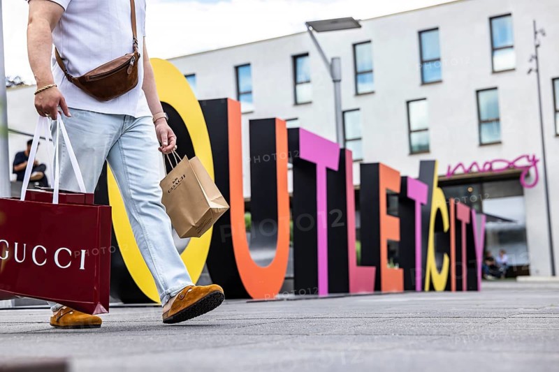 Shopping in Outletcity Metzingen. The 500 premium and luxury brands focus on clothing, but also offer beauty and home products. Outletcity AG around Hugo Boss is the first and one of the largest outlet locations in Germany. Gucci shopping bag. Metzingen, Baden-Württemberg, Germany