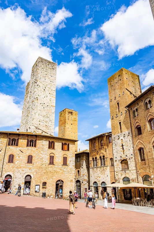 Towers of the old Town with historic buildings from Piazza della Cisterna at San Gimignano on a sunny day, Tuscany, UNESCO World Heritage, Italy, Europe, Europe