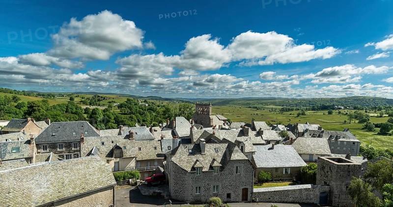 Saint Urcize. Aubrac Regional Natural Park. View of the village and the Romanesque church of Saint-Pierre and Saint-Michel with its comb-shaped bell tower. Cantal department. Auvergne Rhone Alpes. France
