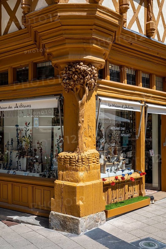 Detailed view of the medieval Maison d'Adam with historic half-timbering, large shop windows and the distinctive oakwood column of the Tree of Life on a street corner in the old town of Angers, Maine-et-Loire department, Pays de la Loire region, France