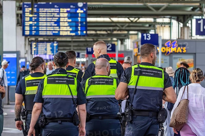 Security personnel at Stuttgart Central Station. DB Security Mobile Support Group. Travelers in the train station. Stuttgart, Baden-Württemberg, Germany