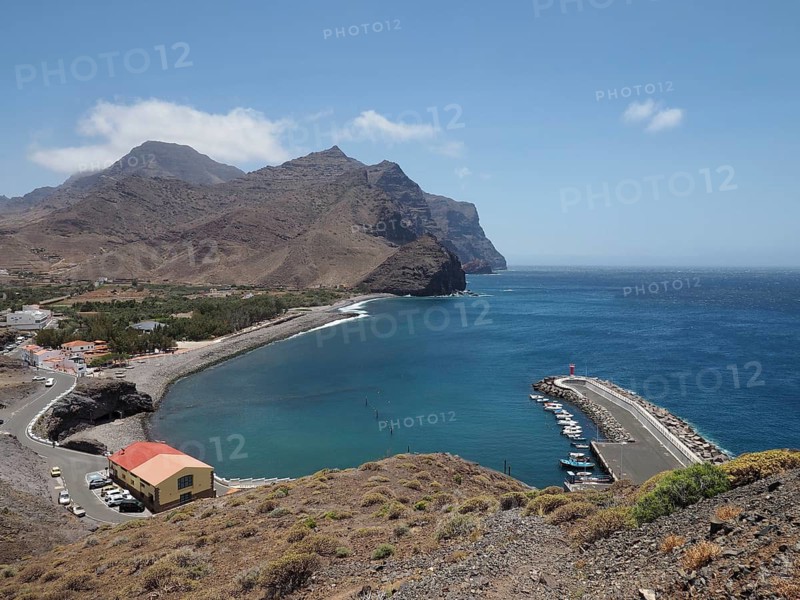 Coastal port with docks and boats against a mountain backdrop, La Aldea de San Nicolas, Gran Canaria, Spain