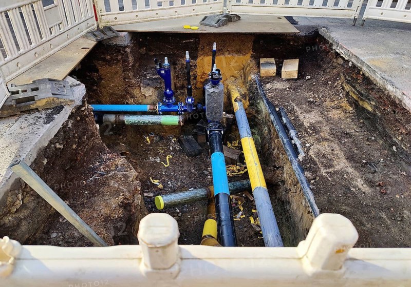 Secured construction site, underground supply lines in the standard colour codes blue for drinking water and signal yellow for gas, Witten