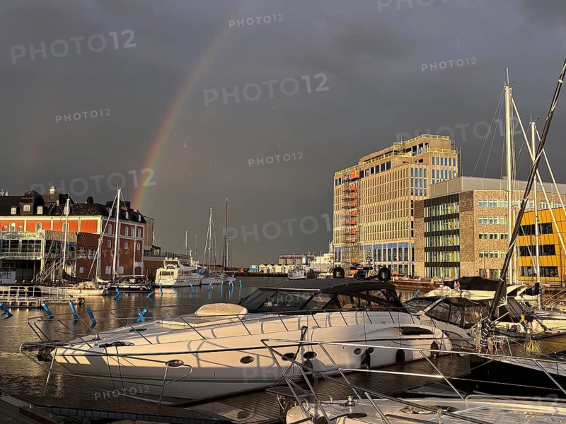 Yachts in harbor near rainbow with modern buildings in background, University, Kalmar, Kalmar Län, Sweden