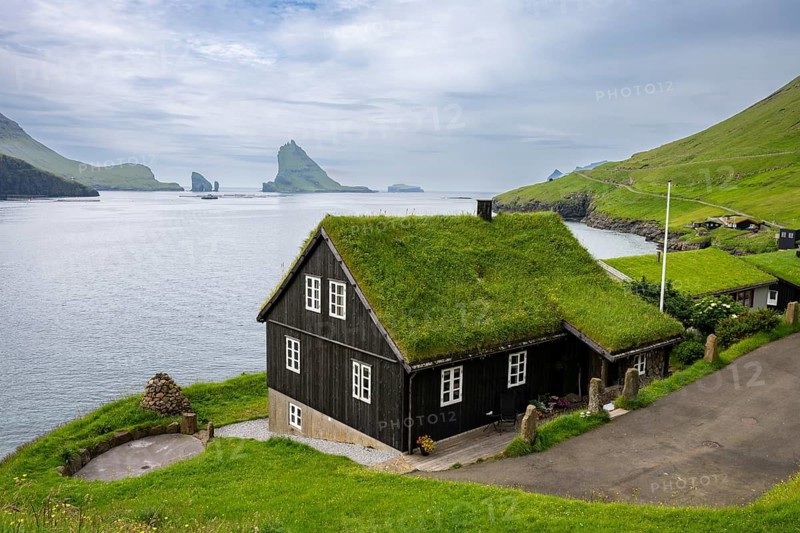Traditional house with grass roof in the village of Bøur, Tindhólmur and Drangarnir, Vágar Island, Faroe Islands, Denmark