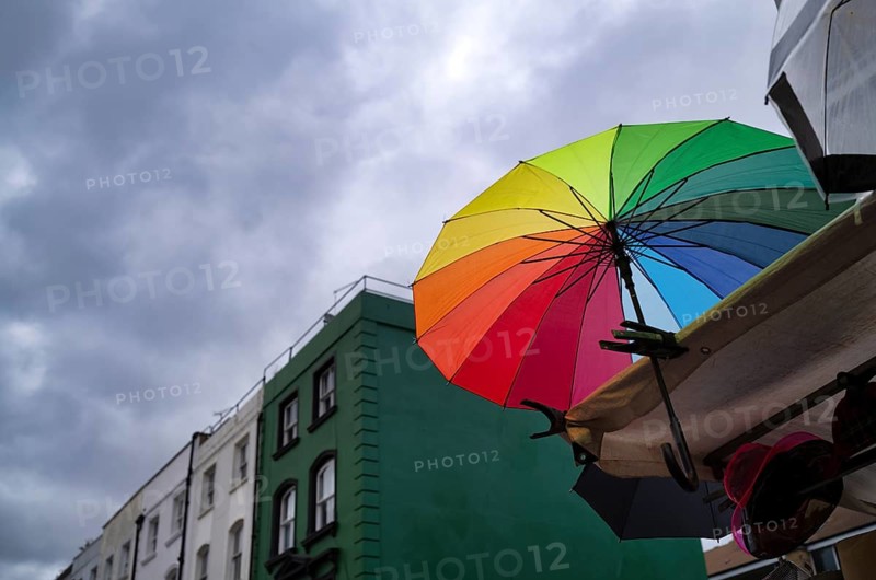Market stand, coloured umbrella, rainbow colors, rain clouds, dark clouds, Portobello Road Market, market, Saturday market, Notting Hill, Kensington, London, England, Great Britain, Great Britain