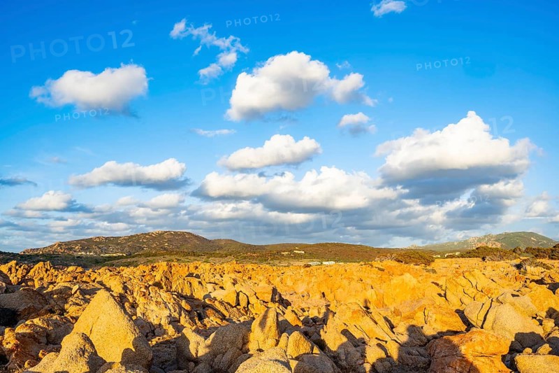 Evening atmosphere with clouds over the landscape at Marinedda Coast on a sunny day, Sardinia, Italy