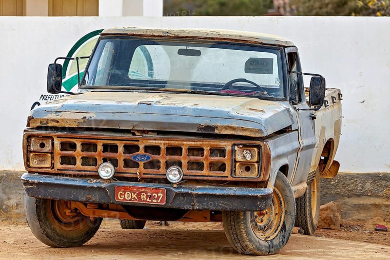 Old, rusted blue Ford truck in a rural setting, an old pickup truck on the road in Bahia Brazil
