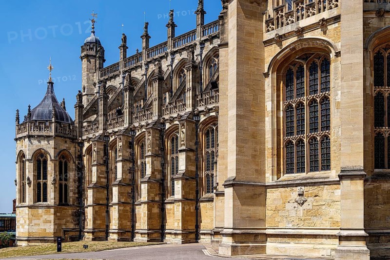 Tiered flying buttresses and tall traceried windows line the south side of St George's Chapel, begun by Edward IV in 1475 and completed under Henry VIII, a Perpendicular Gothic masterpiece that serves as the spiritual home of the Order of the Garter, Windsor, England, United Kingdom