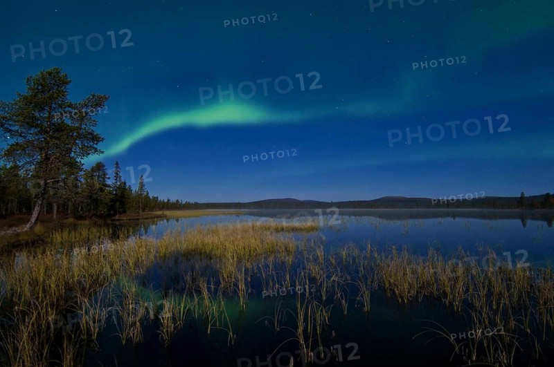 The Northern Lights (Aurora borealis) reflected in a lake, Gällivare, Lapland, Sweden