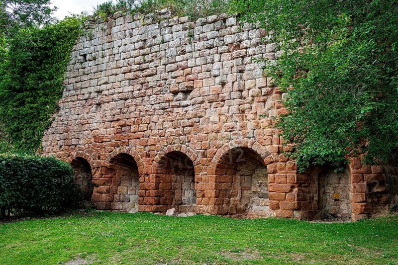 The ruined sandstone wall and arched vaults of the 14th-century Rosslyn Castle stand in Roslin, Midlothian, Scotland, United Kingdom