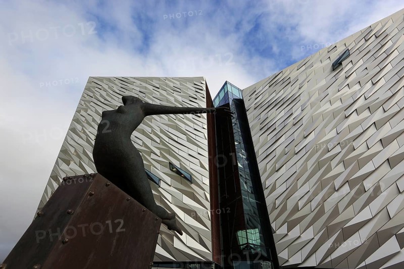 Titanica sculpture by Rowan Gillespie in front of the building, Titanic Museum in Belfast, Northern Ireland, The Titanic Belfast is a visitor attraction that opened in 2012 and represents a monument to Belfast's maritime heritage on the site of the former Harland & Wolff shipyard in the Titanic district of the city where the RMS Titanic was built