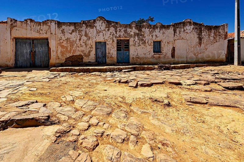 Dilapidated buildings on eroded soil on a clear day, settlement and villages in the Caatinga of Pernambuco and Bahia in Brazil
