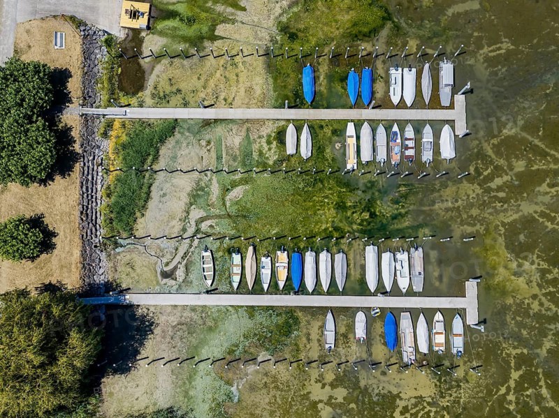 Drought on Lake Constance. The marina of Mannenbach-Salenstein in the canton of Thurgau is almost completely dry. Boats are dry at the dock and can no longer get into the water. aerial view. Mannenbach-Salenstein, Canton of Thurgau, Switzerland