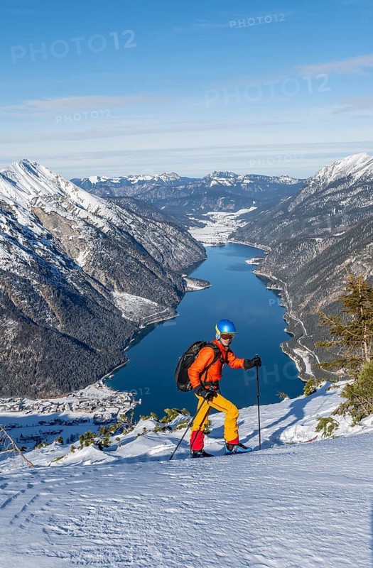Picturesque view of Achensee and wintry mountain scenery, ski tourers at the summit of Bärenkopf, Achensee, Tyrol, Austria