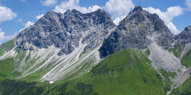 A sweeping mountain panorama from the Älpelesattel at 1, 780 m, stretching towards the striking peaks of the Großer Wilder (2, 379 m), and the Kleiner Wilder (2, 306 m), here, the Alps reveal themselves in all their diversity, with rugged rock faces, green cirques and vast skies – the Allgäu Alps, Allgäu, Bavaria, Germany