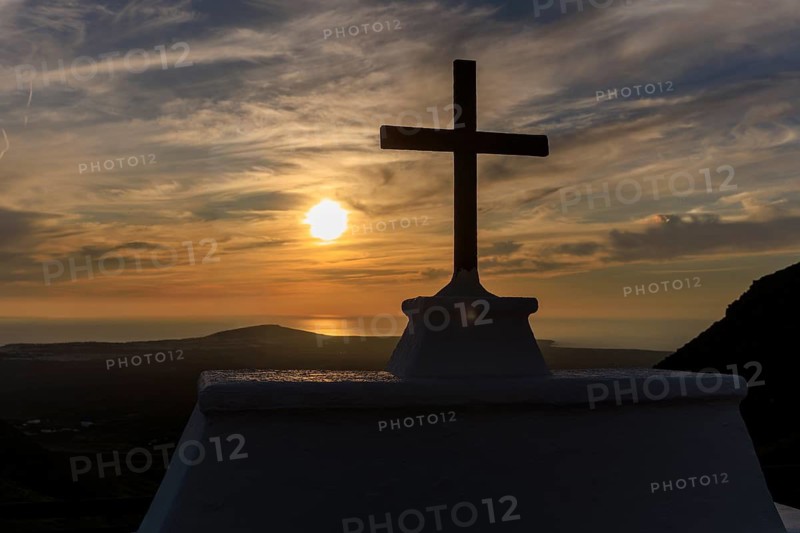 Lanzarote, Canary Islands, Spain, Europe, Femes at the Ermita de San Marcial de Rubicon, A cross in the foreground in front of a picturesque sunset over the sea