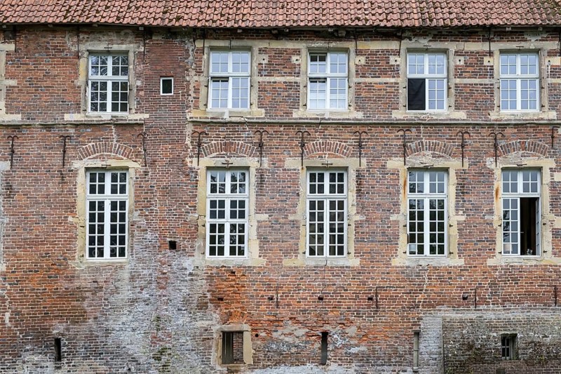 Historic façade of a brick building with several white windows, Münsterland, North Rhine-Westphalia, Germany