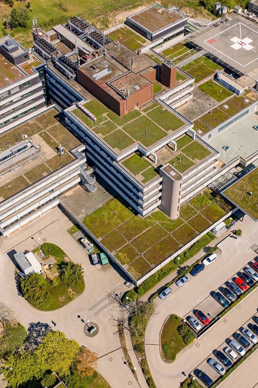 Roof view of a large hospital complex with lots of parking spaces and surrounding trees, Nagold Hospital of the Southwest Clinic Network, Calw district, Germany