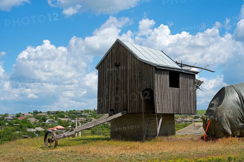 Wooden windmill in a field under blue sky with clouds in the background, surrounded by rural landscape, windmill, Besalma, Be?alma, Comrat district, Gagauzia autonomous region, Republic of Moldova, Moldova