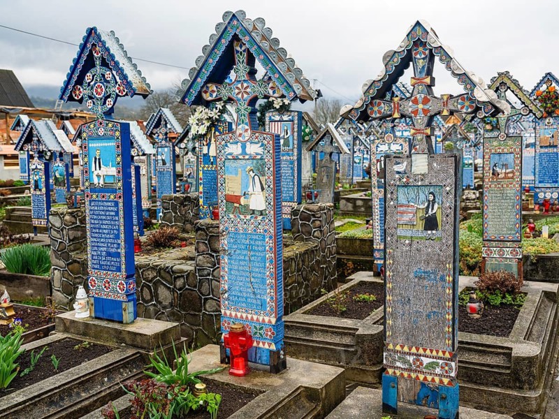 Colourfully painted wooden crosses in the cheerful Cimitirul Vesel cemetery, Sapân?a, Maramure?, Romania