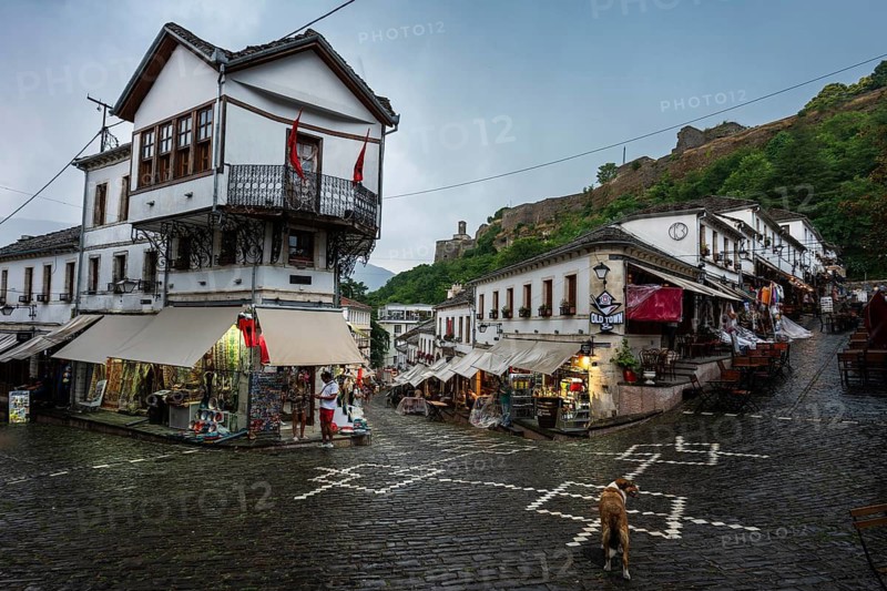 GJIROKASTER, ALBANIA - JUNE 30, 2026: Traditional Albanian street in Gjirokastër during rainy day